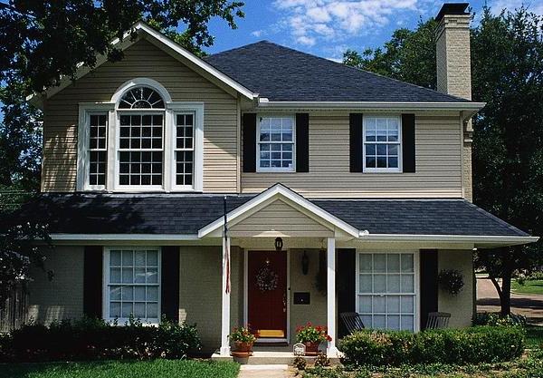 Light brown house with shutters.